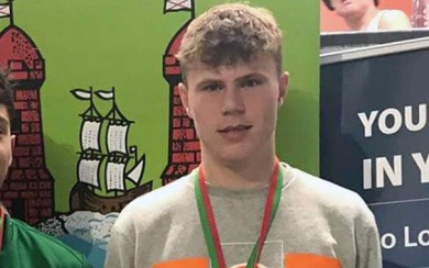 Ben Hannafin collecting the bronze medal from Mary Haughney at Michael Bowles Gala in Douglas (Cork) (2022)